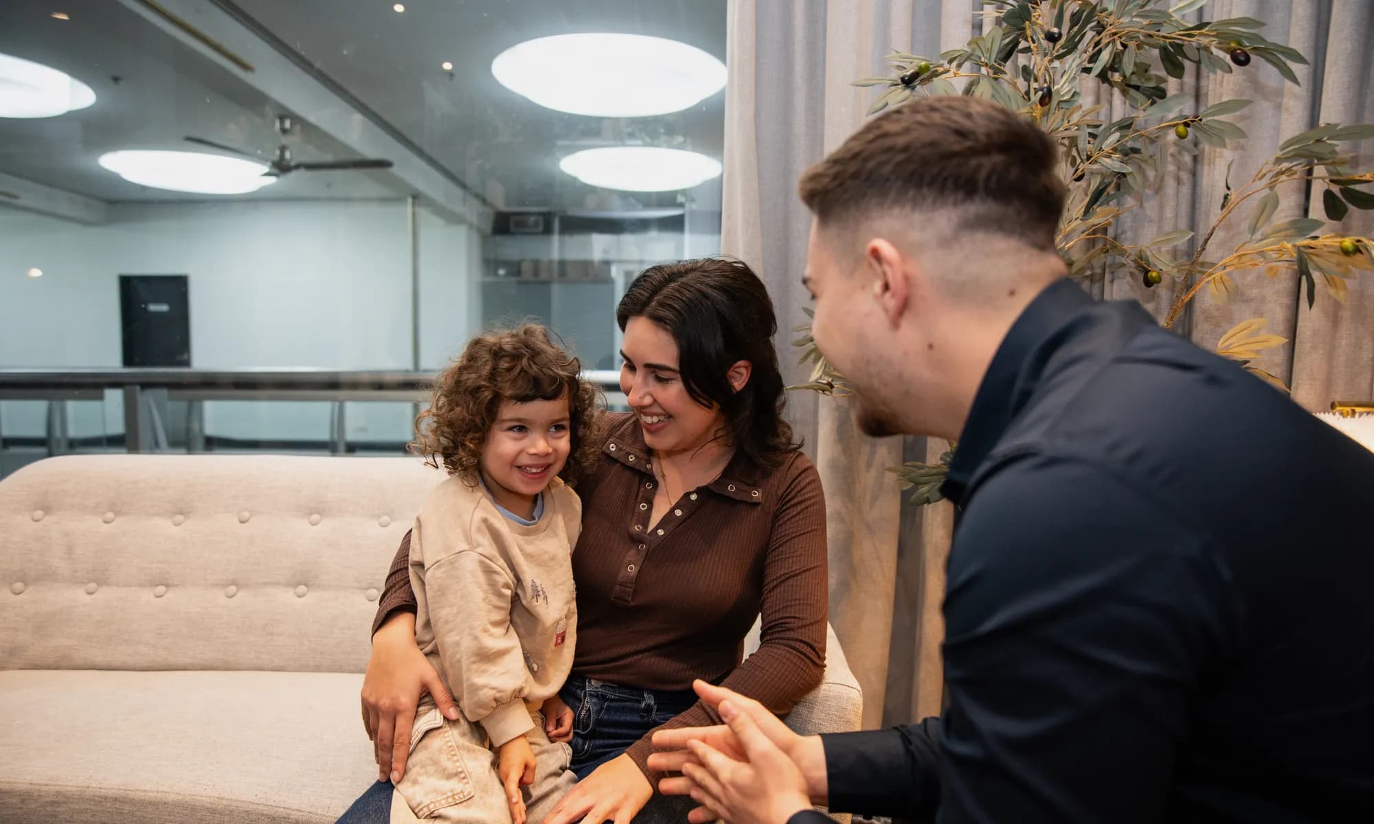 Dr Arthur Kaganovitch with a young patient and their family at Aura in Toorak