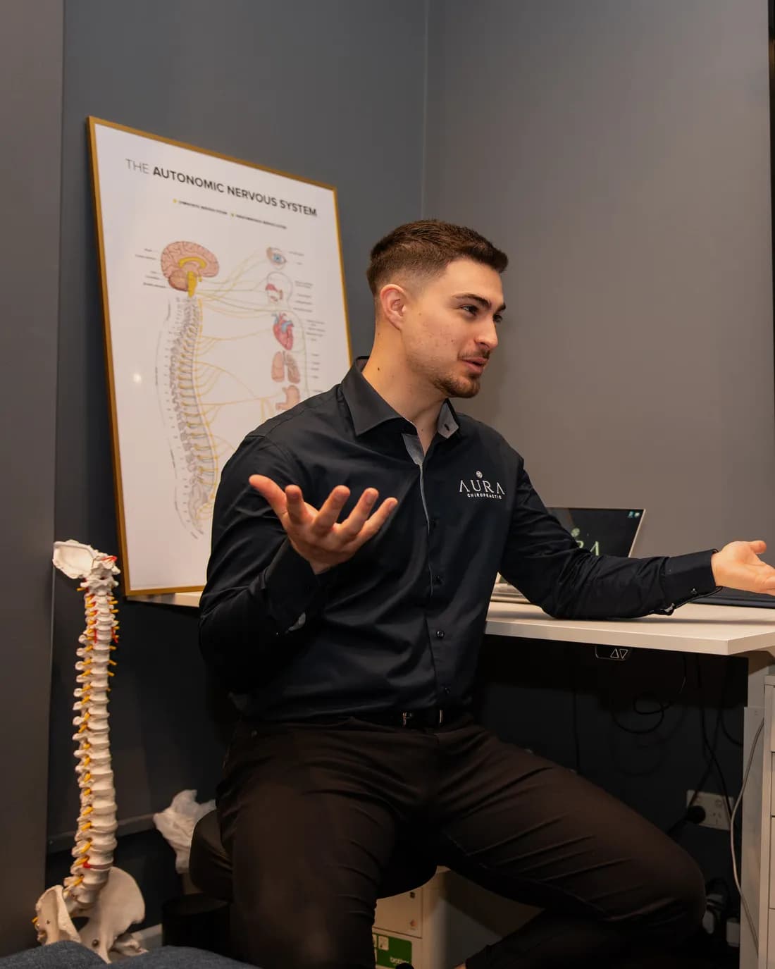 Dr Arthur Kaganovitch reviewing a patient's nervous system results at Aura in Toorak